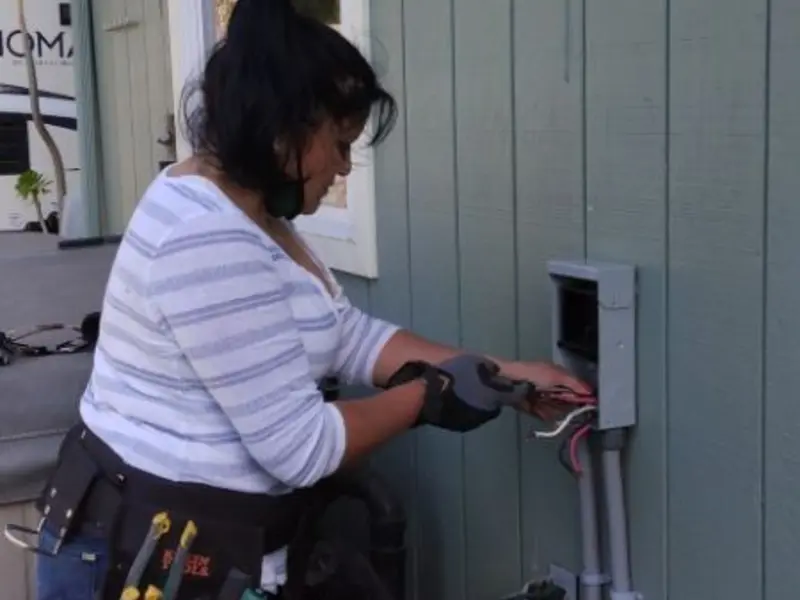 Licensed electrician wiring an exterior subpanel in Applewood